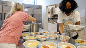 HOPE Atlanta volunteers prepare hot meals at the Women and Children’s Community Kitchen, a legacy program of Action Ministries.